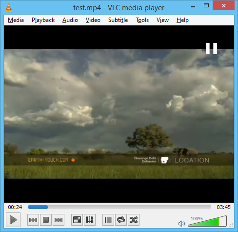 a screen shot of a field with clouds in the background